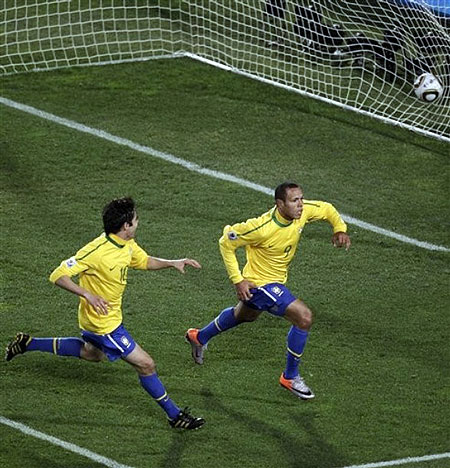 Brazil's Luis Fabiano, right, celebrates with fellow team member Kaka, left, after scoring the second goal during the World Cup round of 16 soccer match between Brazil and Chile at Ellis Park Stadium in Johannesburg, South Africa, Monday, June 28, 2010.